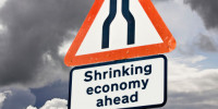 Shrinking economy, recession concept UK against a stormy sky